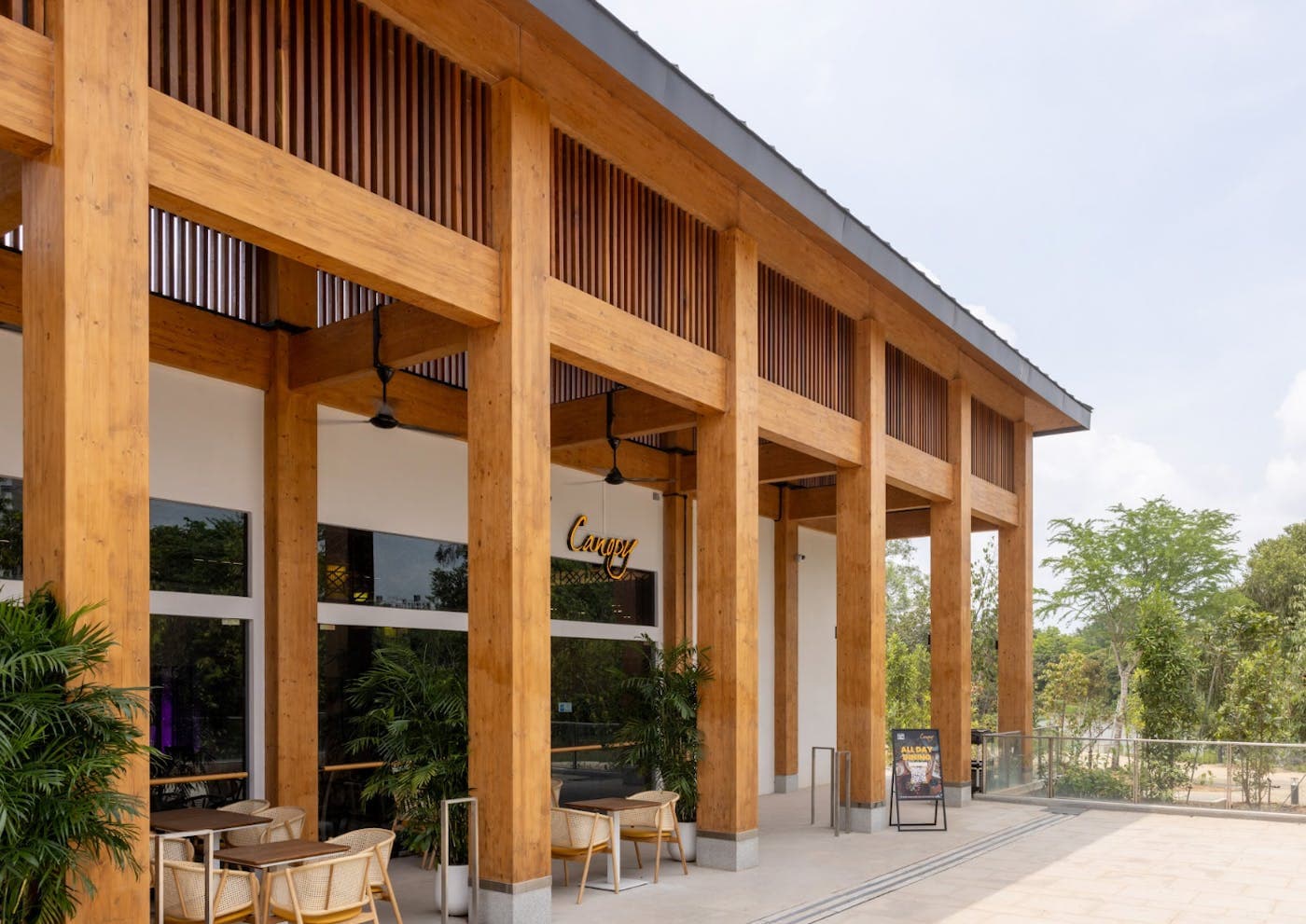 The timber colonnade of the pavilion, the sea beyond