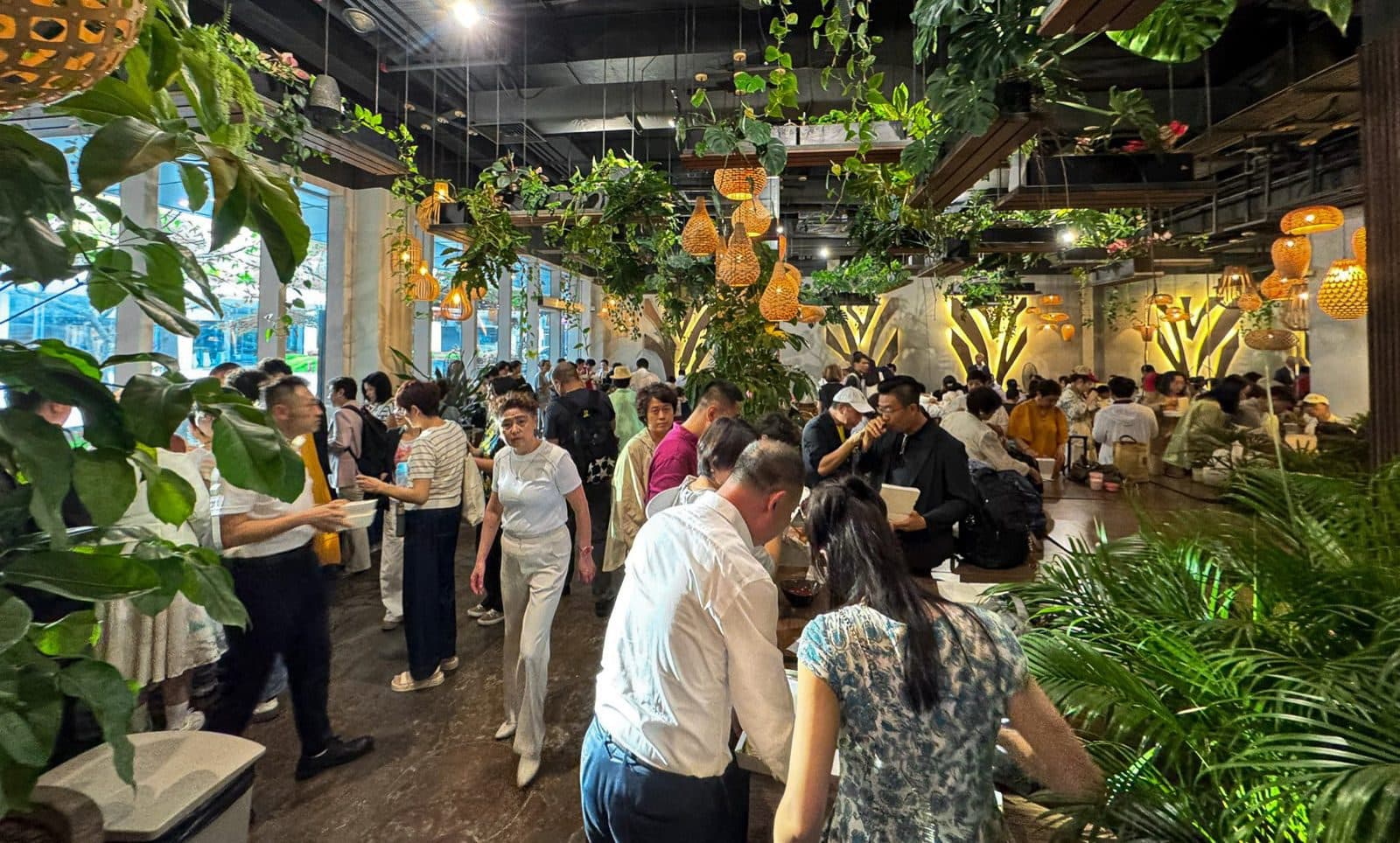 Timber tables under the planting at Canopy Changi City Point