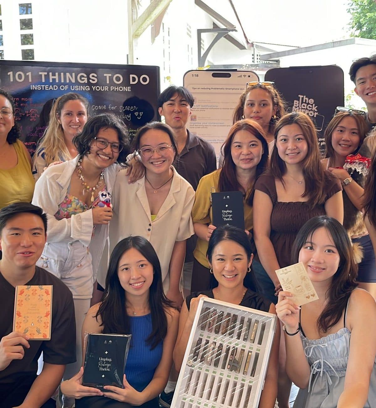 A company group photographed together on the deck at Canopy Changi Village after their event