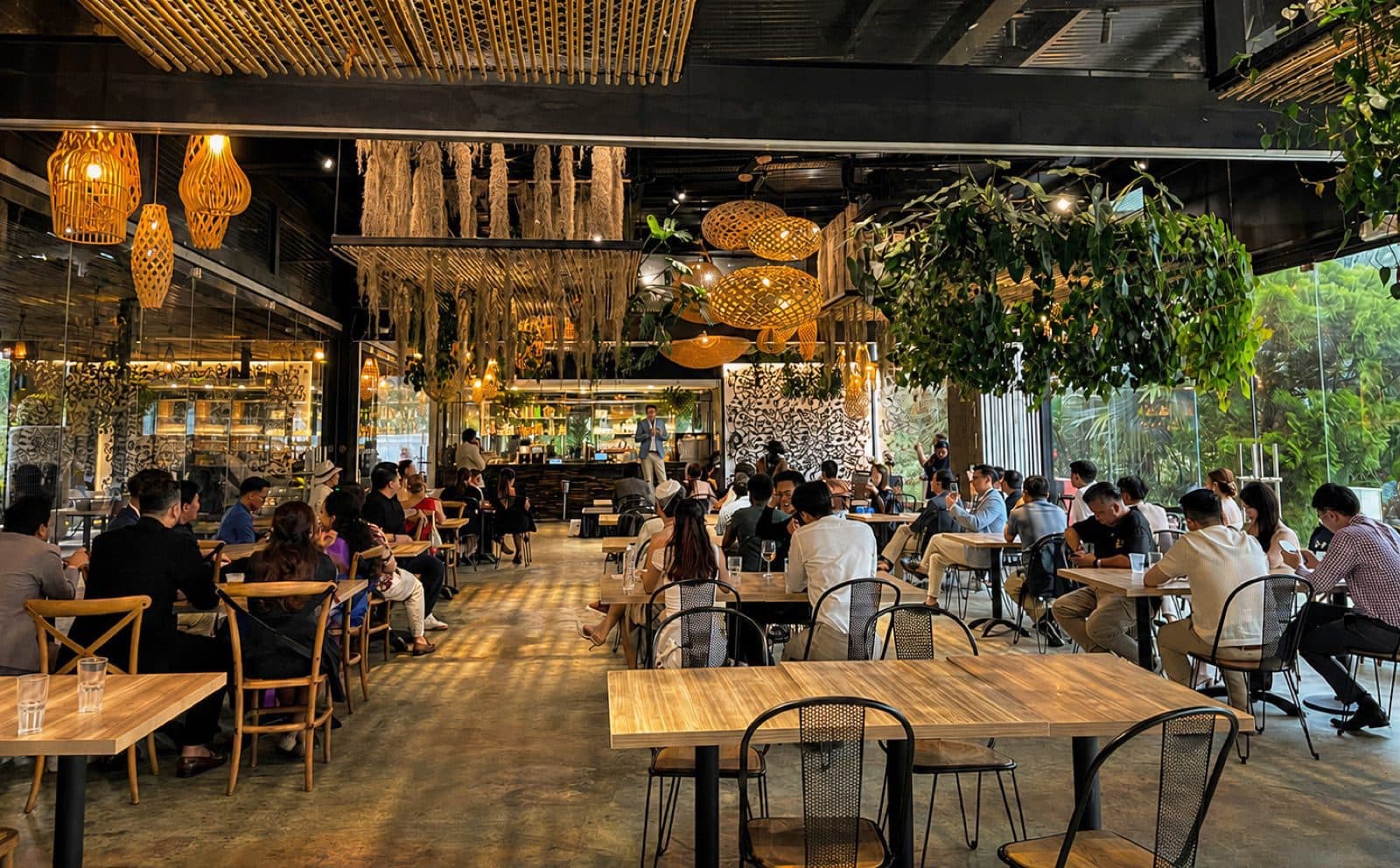 The covered hall at Canopy HortPark, rattan lanterns overhead