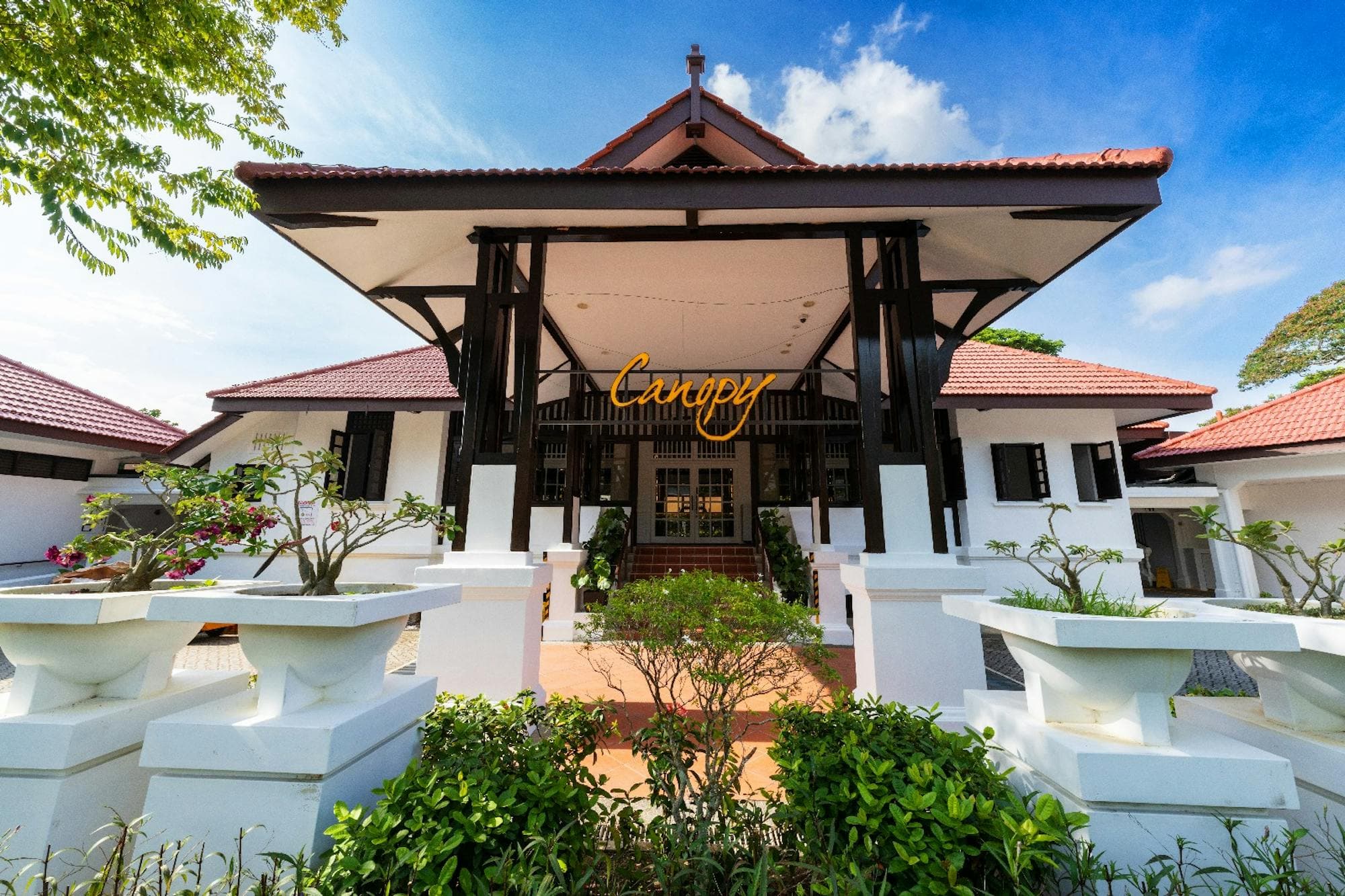 The entrance pavilion at Canopy Changi Village, the Canopy sign under the timber roof