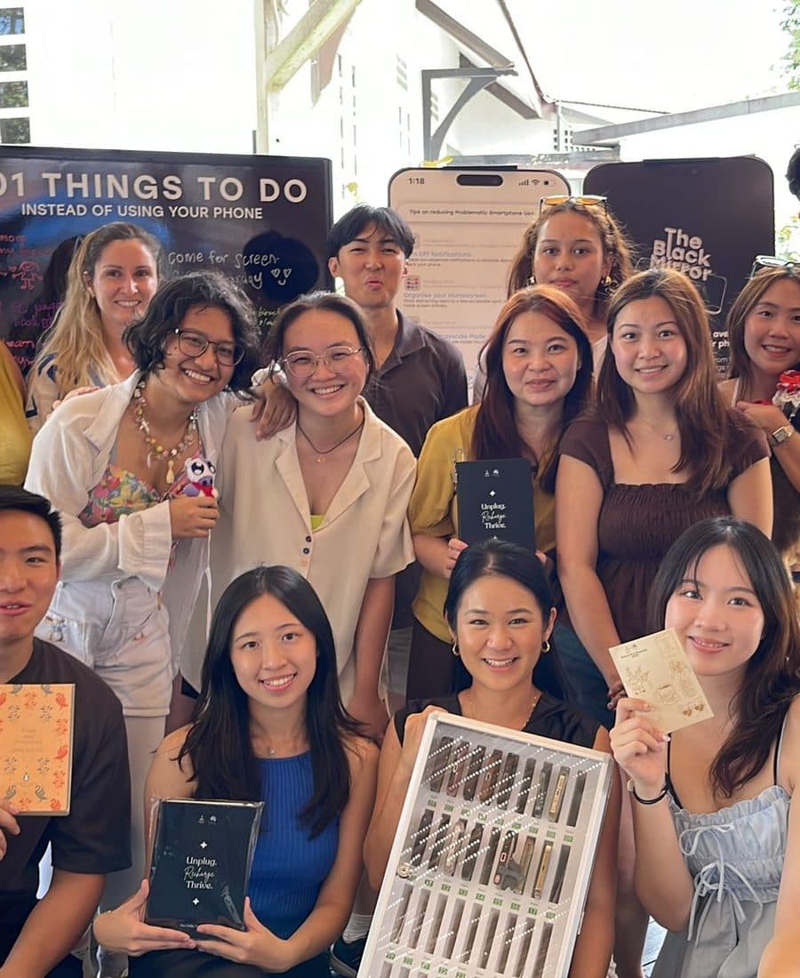 A company group photographed together on the deck at Canopy Changi Village after their event
