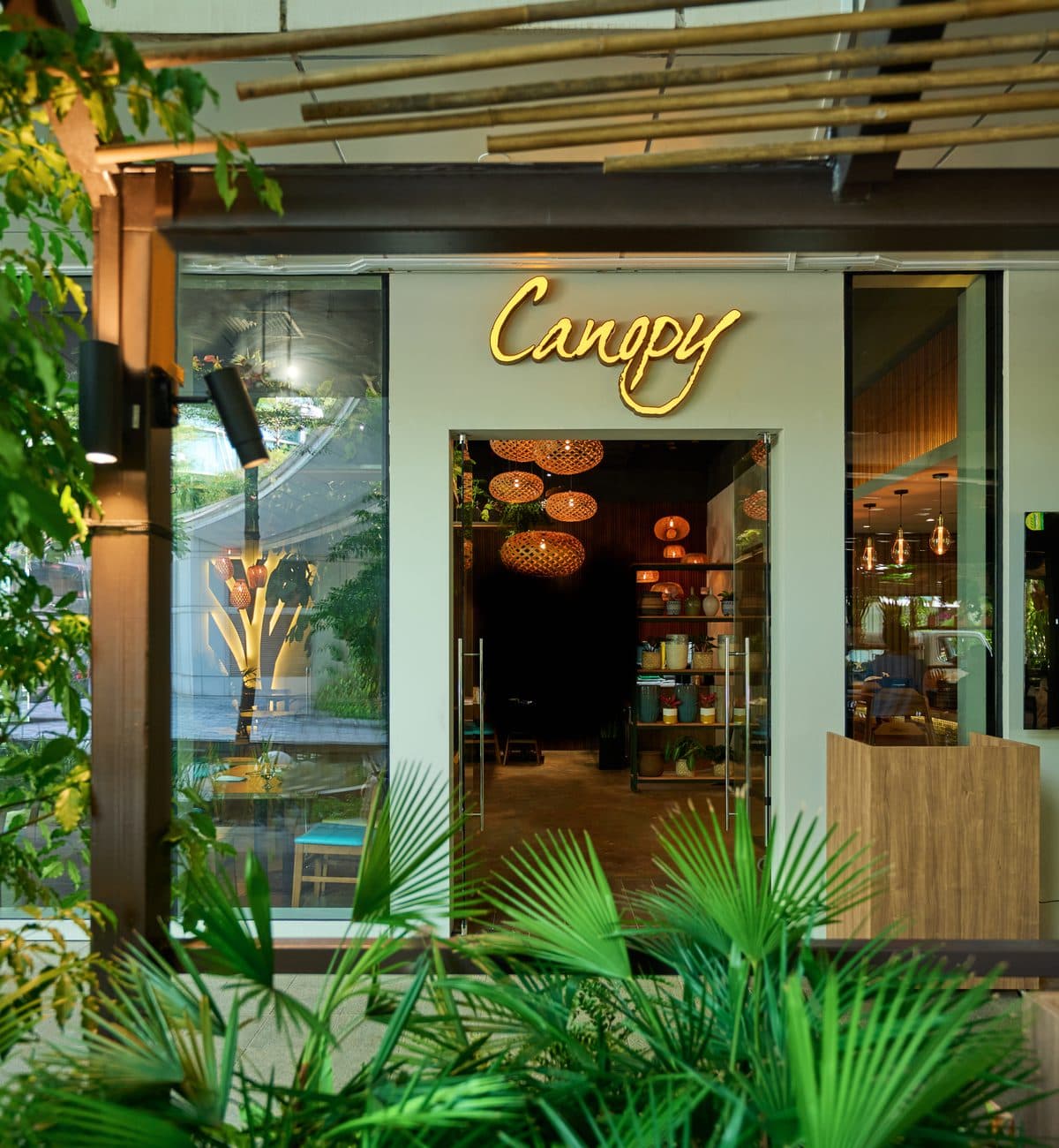 The entrance to Canopy Changi City Point, the honey wordmark above the doors