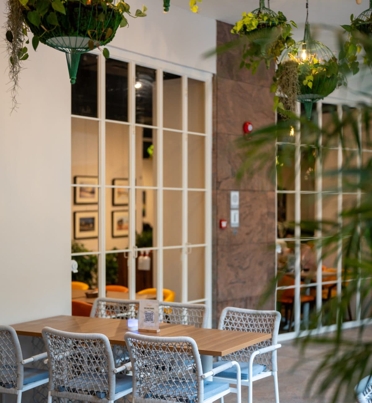 Alfresco seating at Canopy Esplanade beside the arched windows of the arts centre