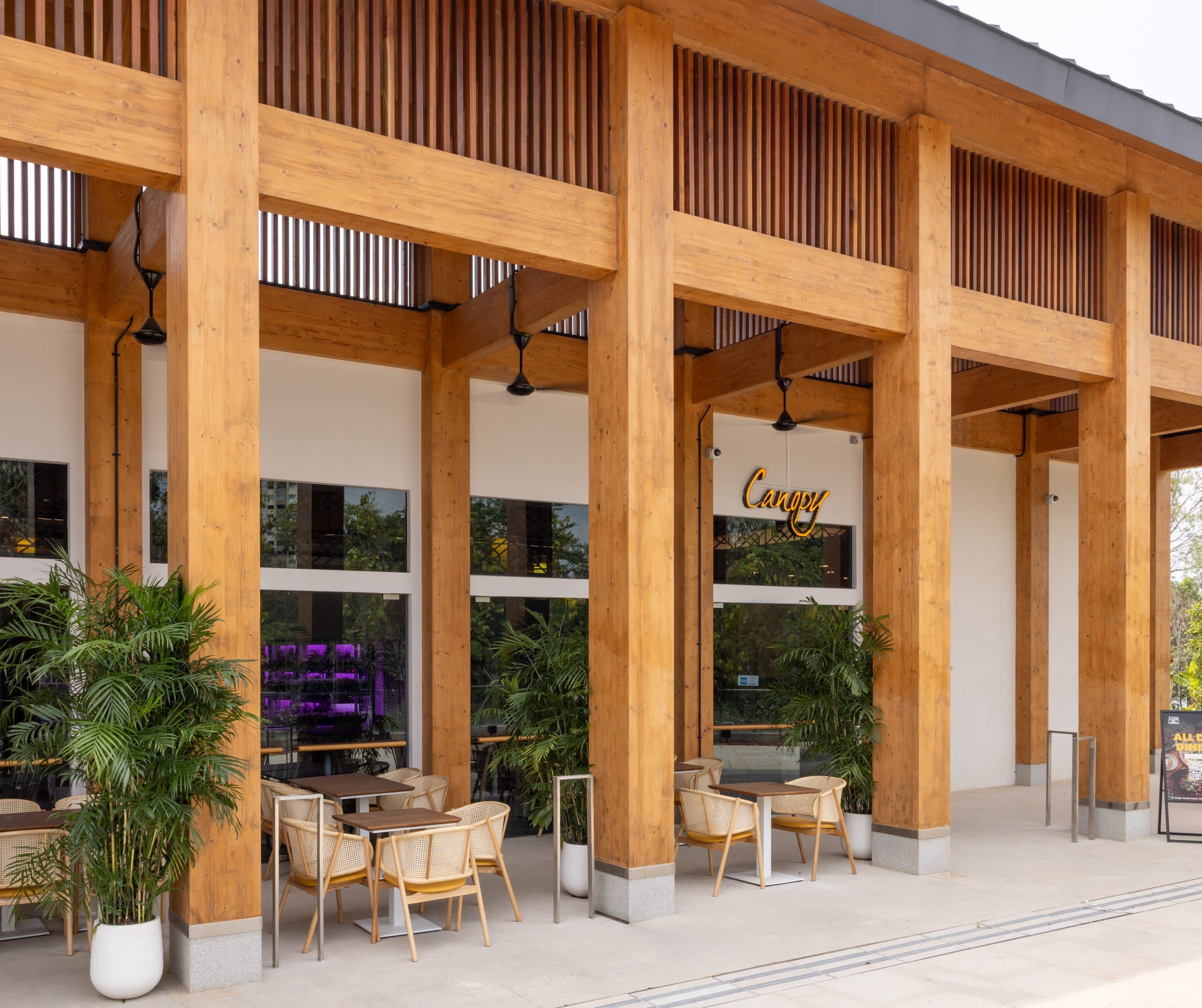 The timber colonnade and terrace tables at Canopy Jurong Lake Gardens