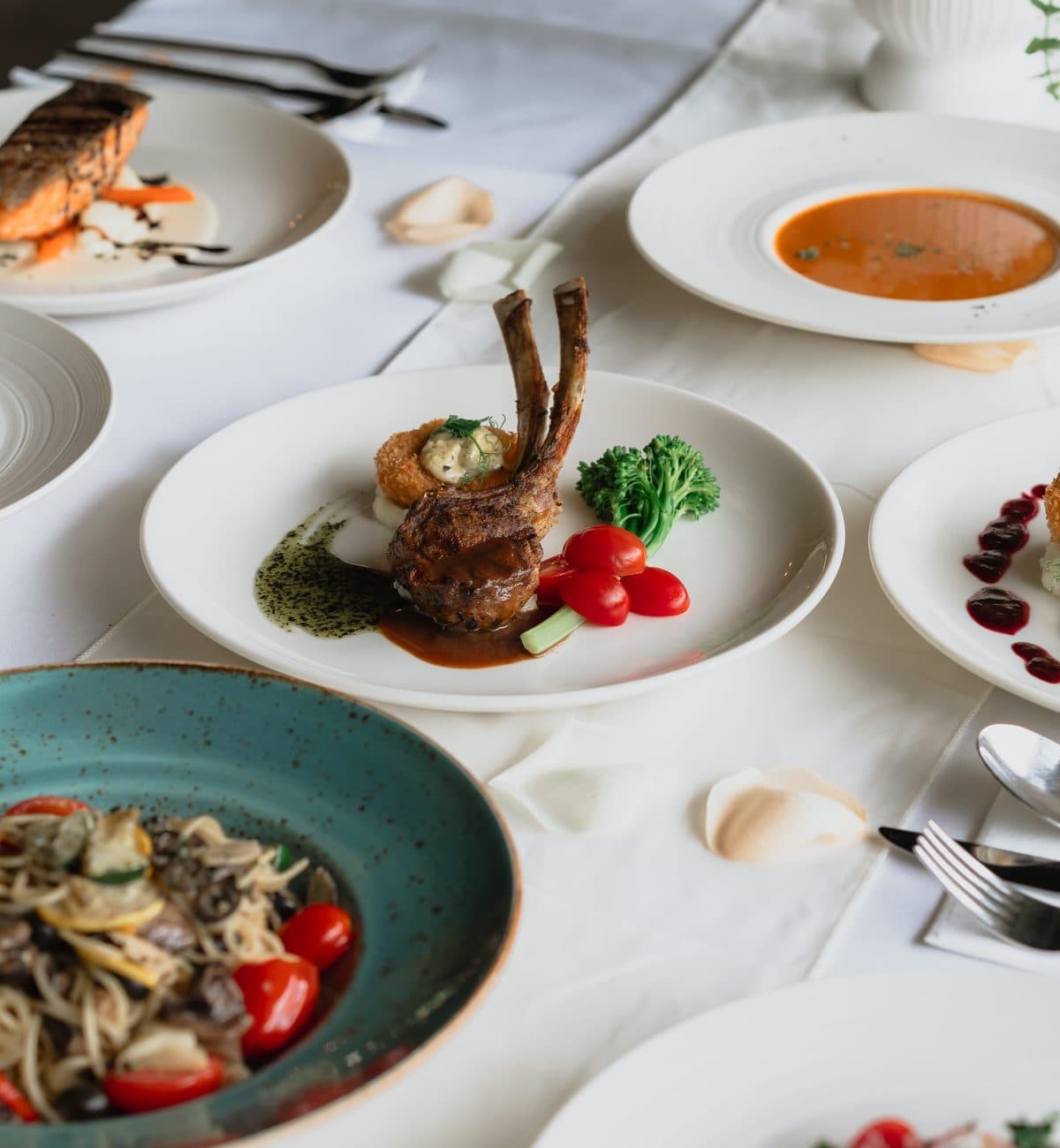 A plated wedding banquet at Canopy HortPark: soup, salmon, lamb rack and pasta