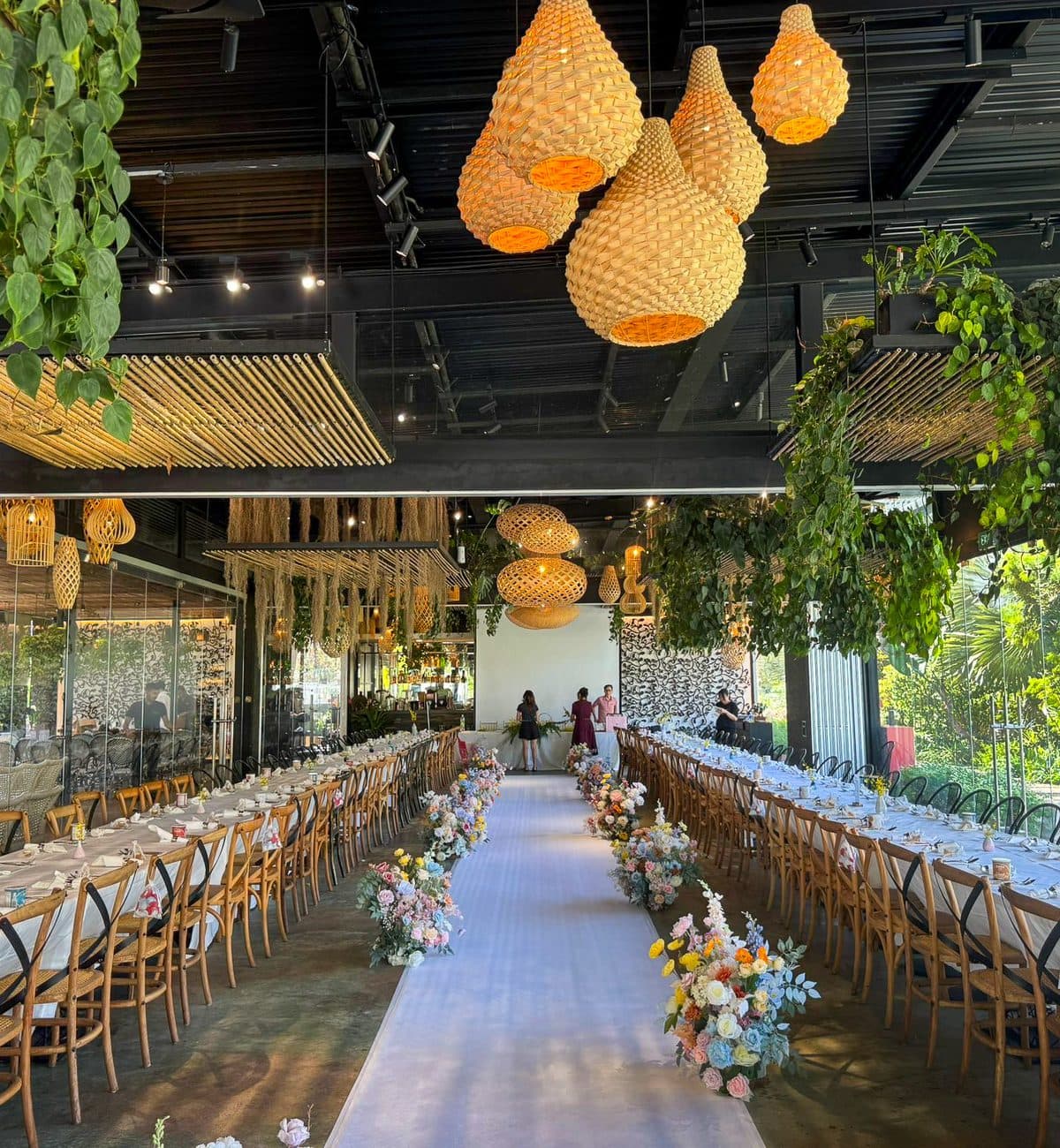 The aisle runner at Canopy HortPark, pastel florals down both sides between two long tables