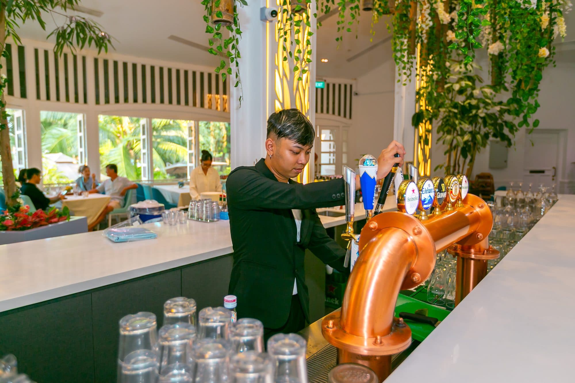 A bartender pouring at the copper tap during the showcase